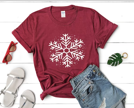 Cricut snowflake design printed on a red t-shirt.